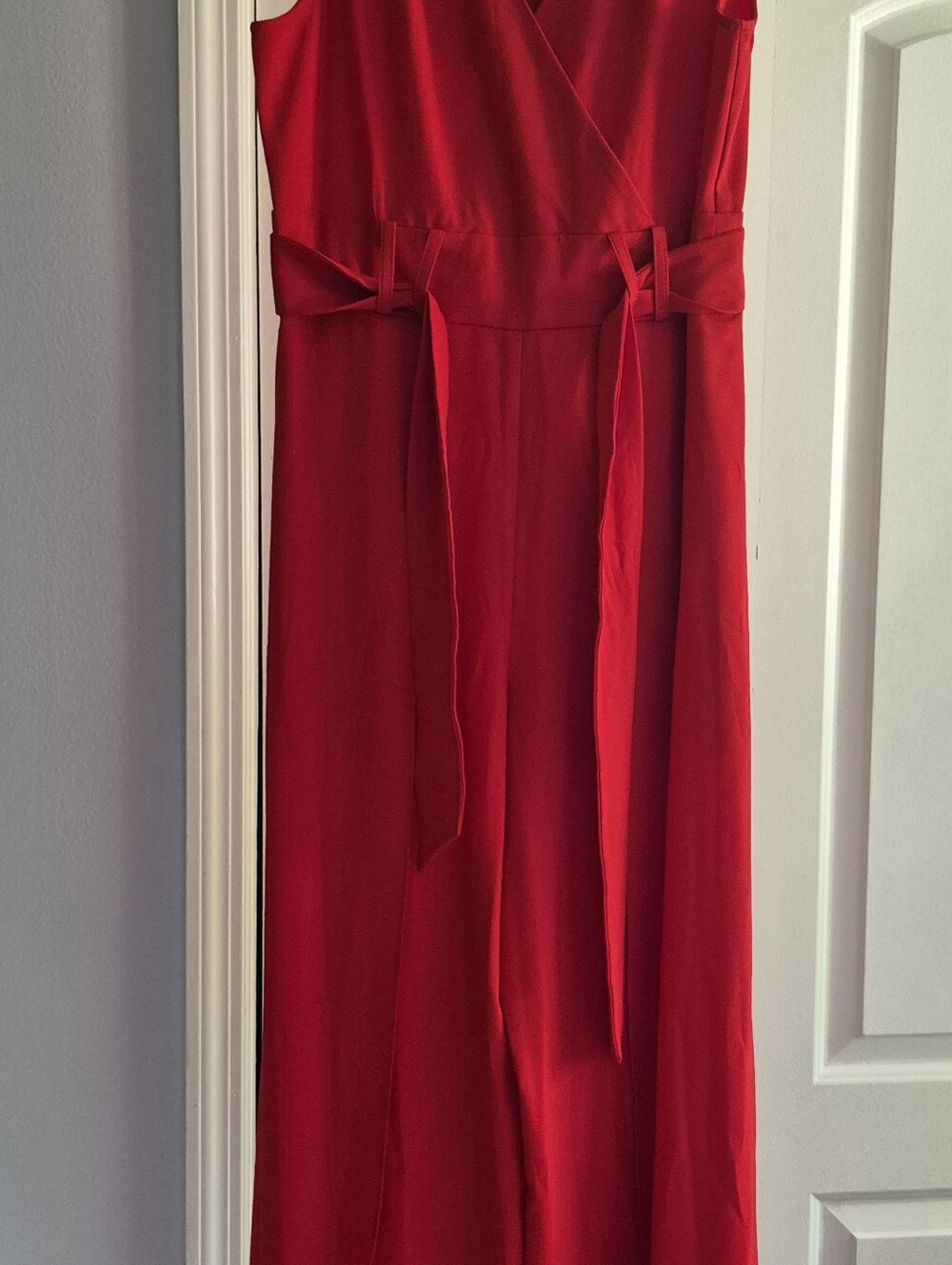 Large red jumpsuit with leg cutouts.